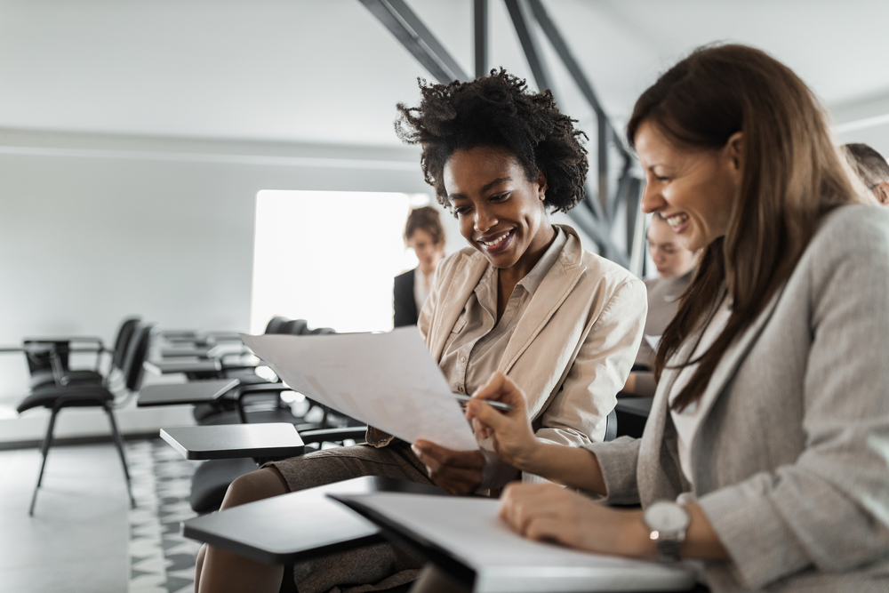 Two professionals reviewing a printed assessment report together.